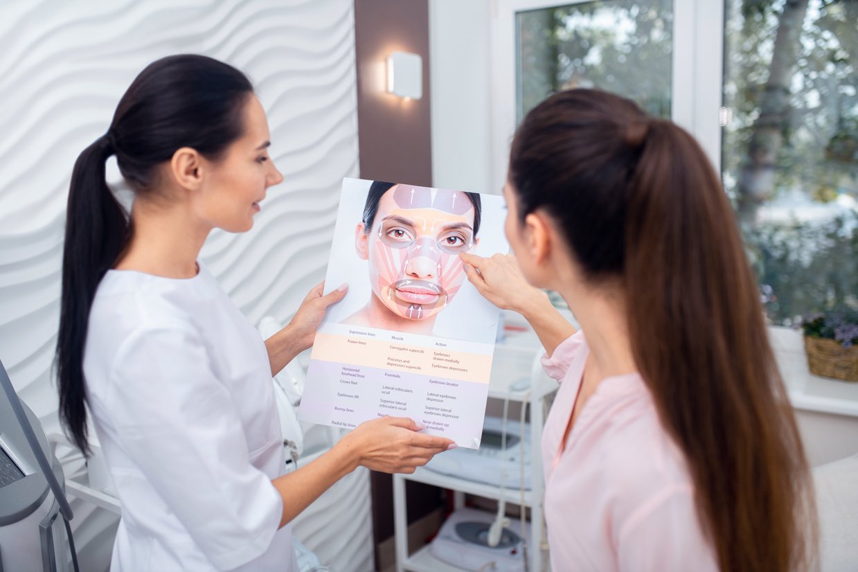 Dark-haired patient asking questions about facial muscles